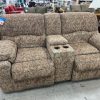 Brown pair of recliners with pattern
